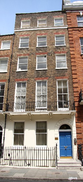 Picture of dental surgery building with blue front door